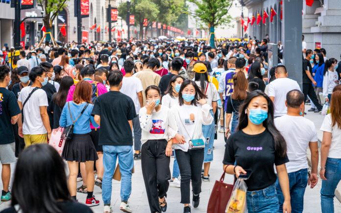 Crowd of people wearing surgical face mask on the 2020 China national day and first day of golden week holidays in Jianghan pedestrian road in Wuhan Hubei China