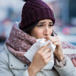 Woman coughing in winter